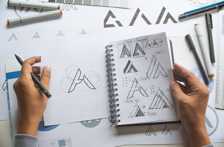 Graphic designer sketching a logo