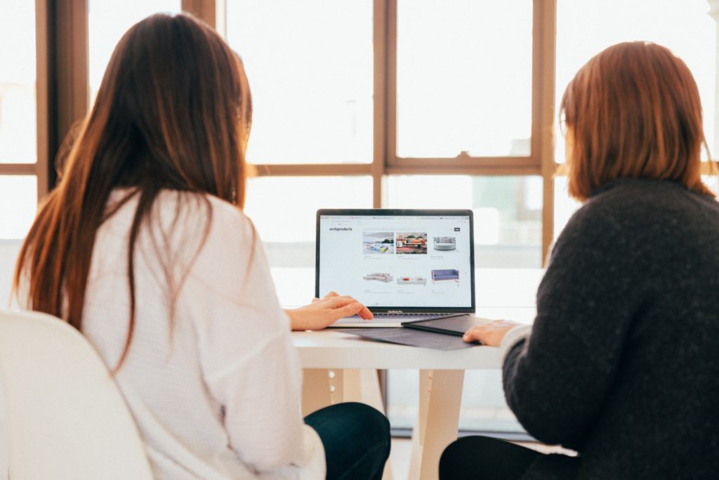 Two women reviewing website